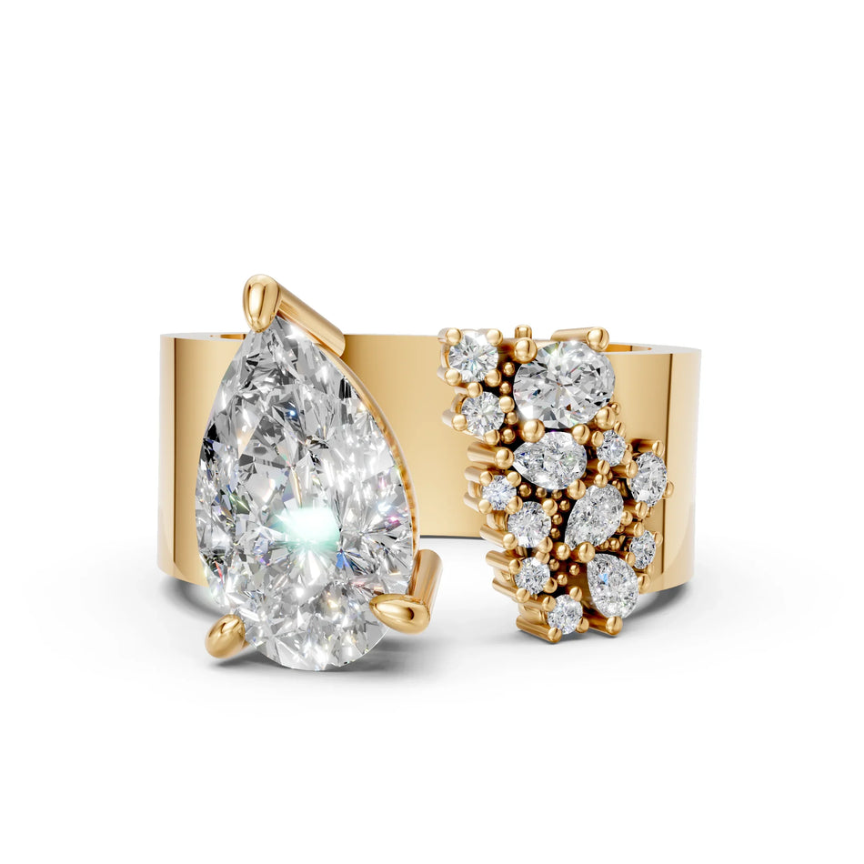 Yellow gold ring with large pear-shaped diamond and cluster of round diamonds