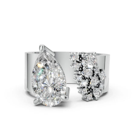 Modern white gold ring with pear-shaped center diamond and clustered accent diamonds