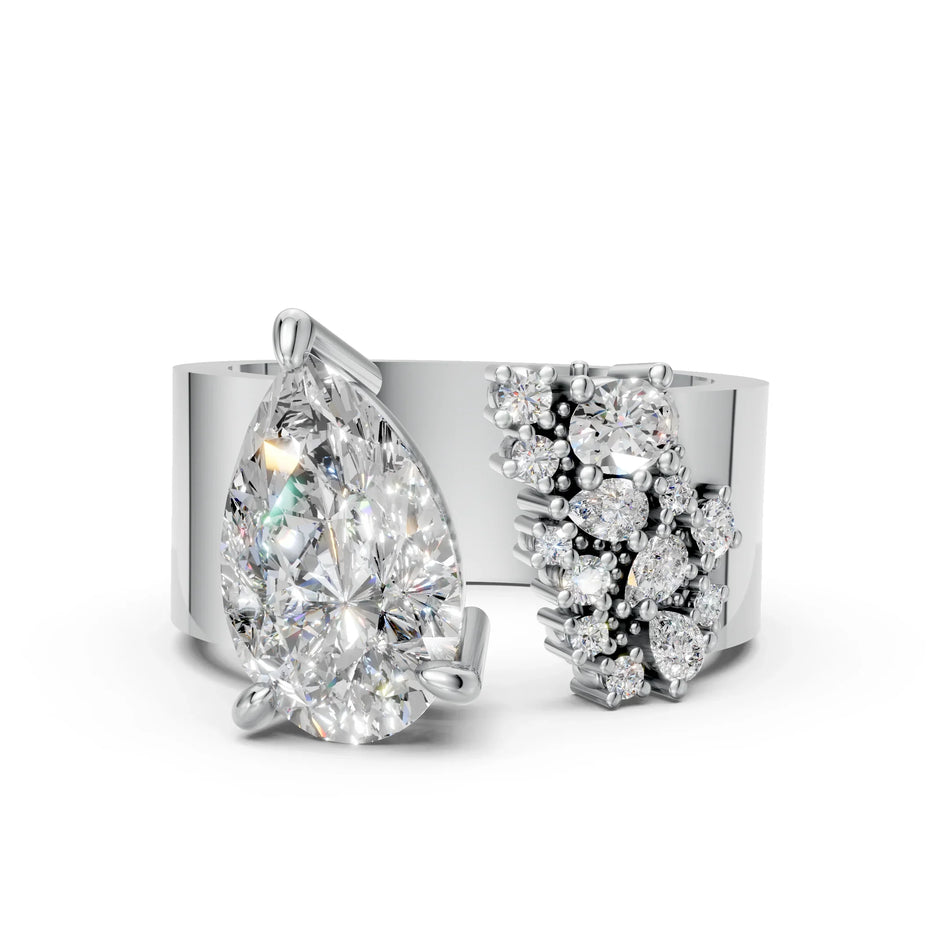 Modern white gold ring with pear-shaped center diamond and clustered accent diamonds