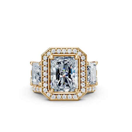 Custom emerald cut diamond engagement ring with halo and side stones in yellow gold