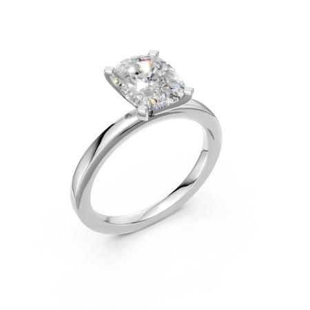 Cushion cut diamond engagement ring with four-prong setting on sleek white gold band