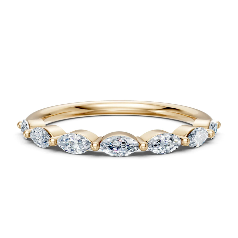 Elegant gold band with oval diamonds, perfect for engagement or wedding rings.