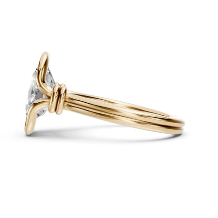 Elegant gold engagement ring with a sparkling diamond and intricate twisted band design.