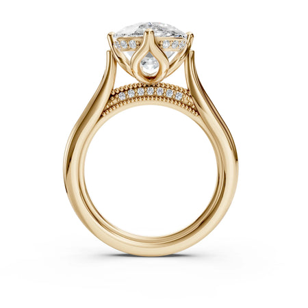 Custom gold engagement ring with round diamond, side stones, and milgrain detailing
