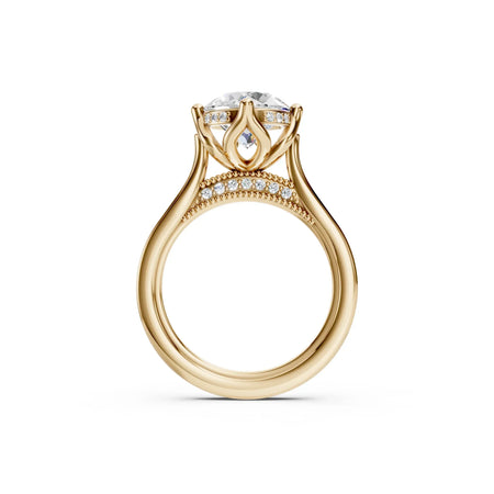 Luxury gold engagement ring with round diamond center, diamond accents, and intricate band design