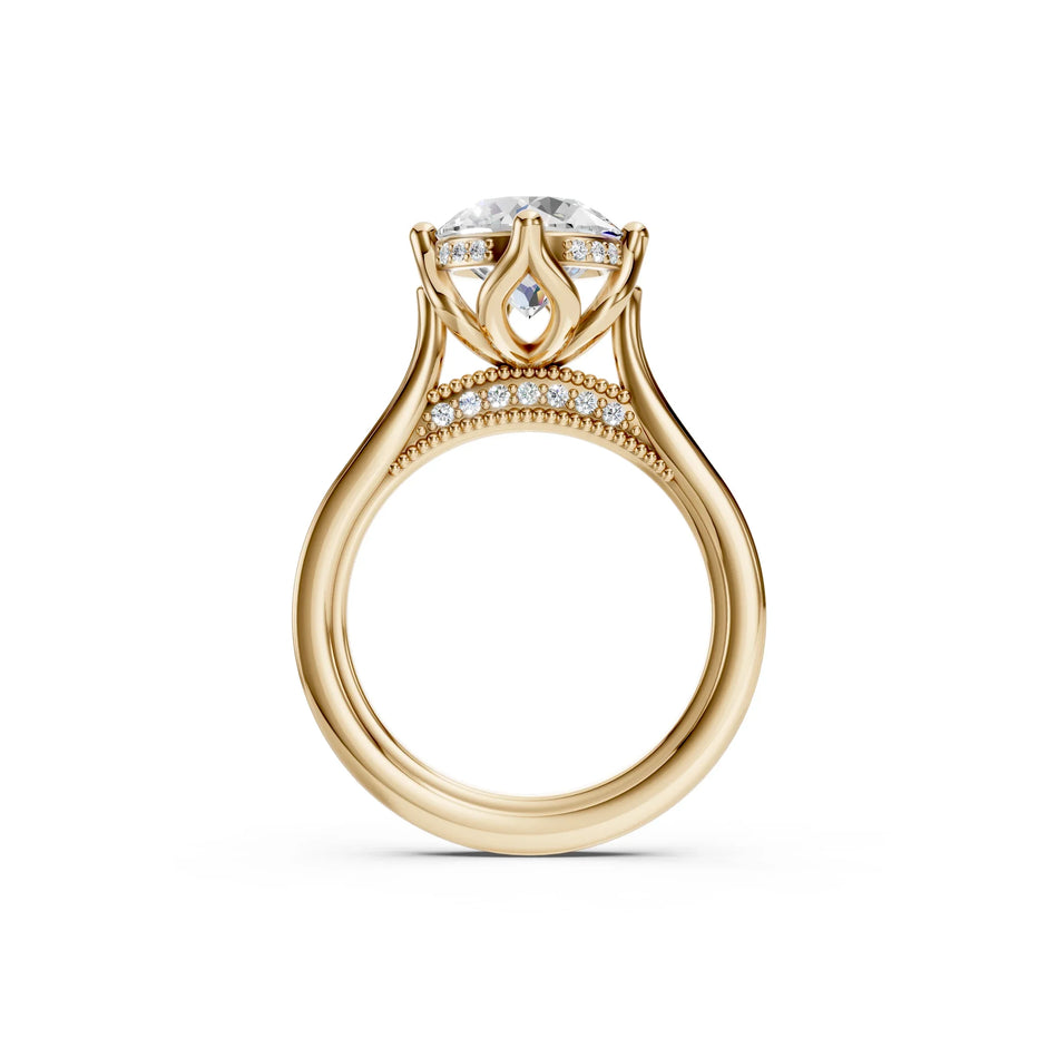 Luxury gold engagement ring with round diamond center, diamond accents, and intricate band design