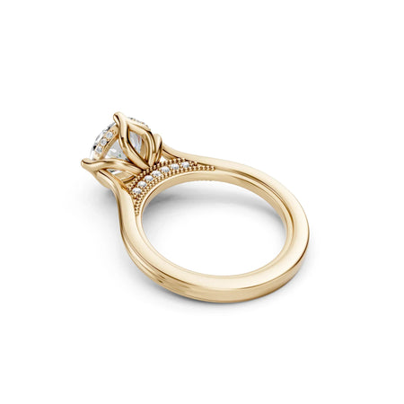 Yellow gold engagement ring with leaf-inspired design, diamond accents, and halo setting