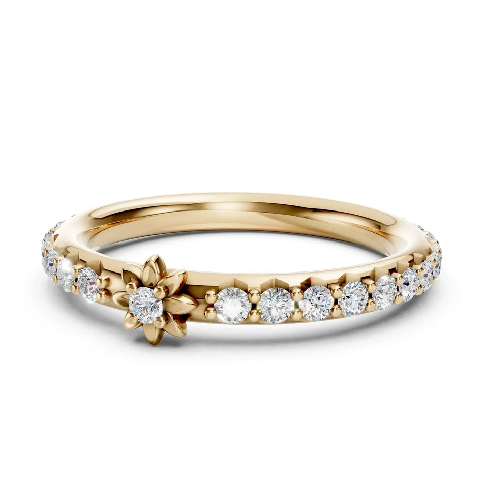 Gold floral engagement ring with a central diamond and pavé diamond band.