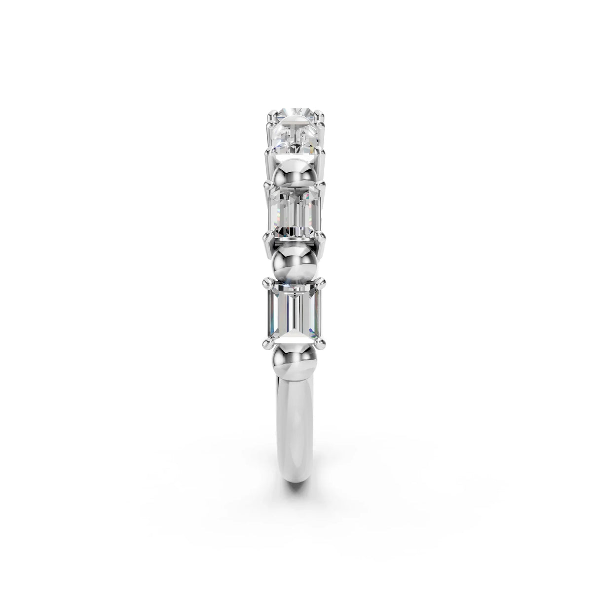 Side view of a white gold ring featuring three emerald-cut diamonds