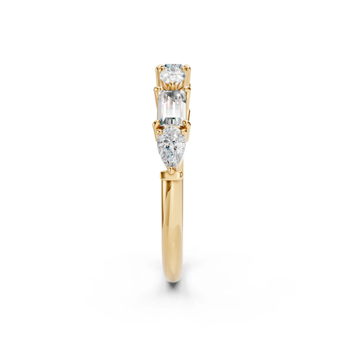 Three-stone diamond engagement ring in yellow gold with round, emerald, and pear cuts