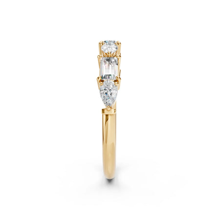 Three-stone diamond engagement ring in yellow gold with round, emerald, and pear cuts