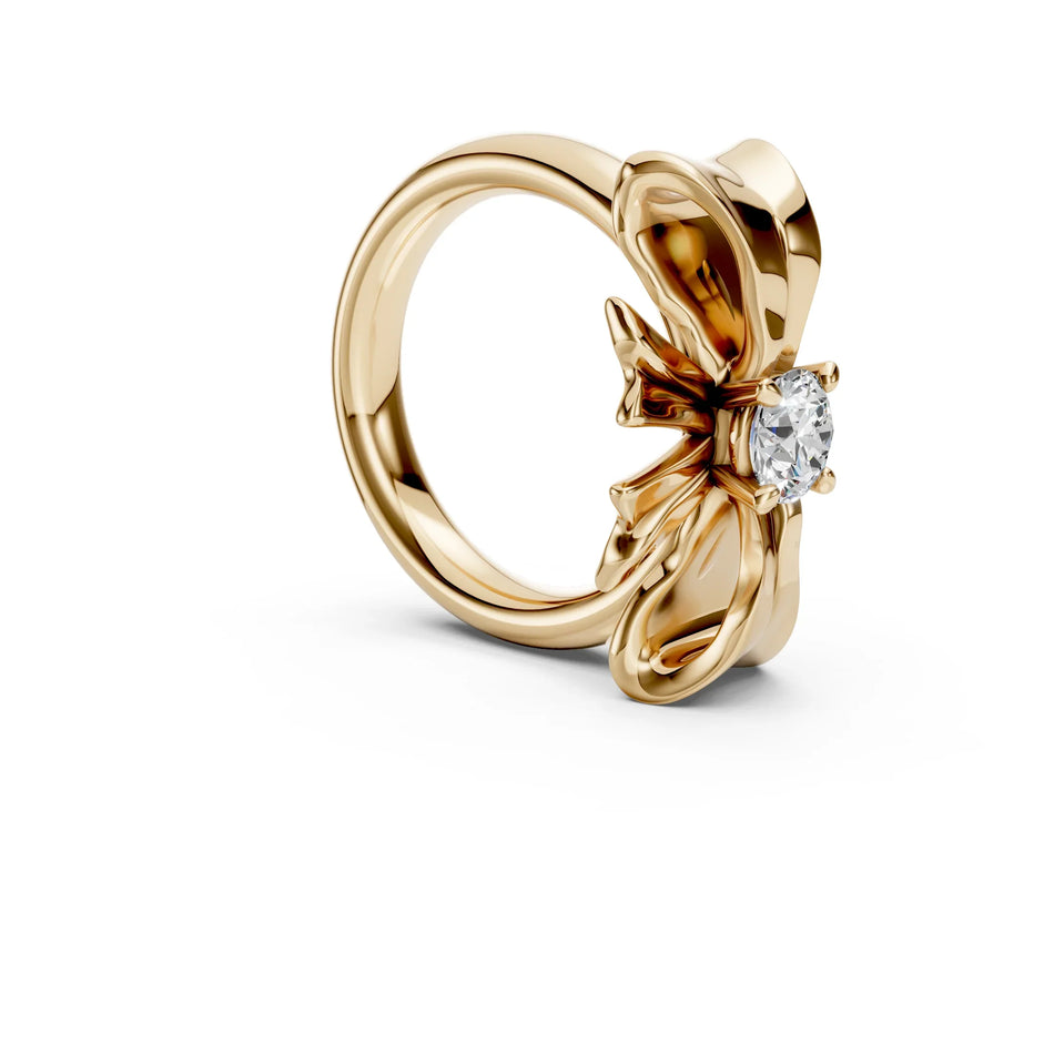 Yellow gold engagement ring featuring a polished bow design and a round brilliant diamond
