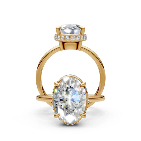 Oval-cut diamond engagement ring with yellow gold band and pavé halo setting
