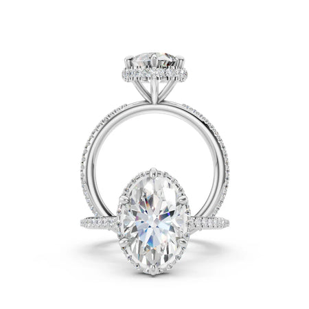 Oval diamond engagement ring with pavé band and halo setting on white background