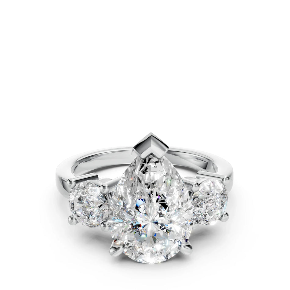 Pear-shaped diamond engagement ring with two round side diamonds on a white gold band