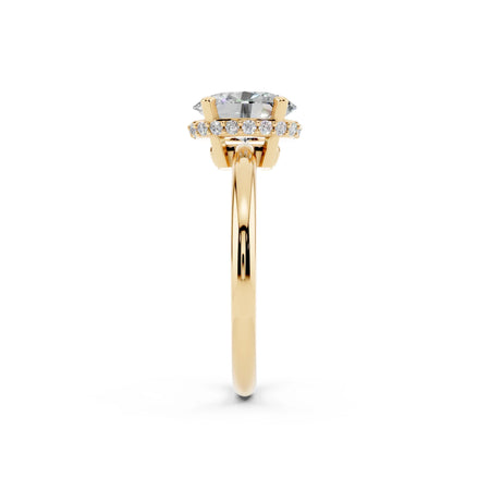 Yellow gold solitaire engagement ring with round diamond and halo setting