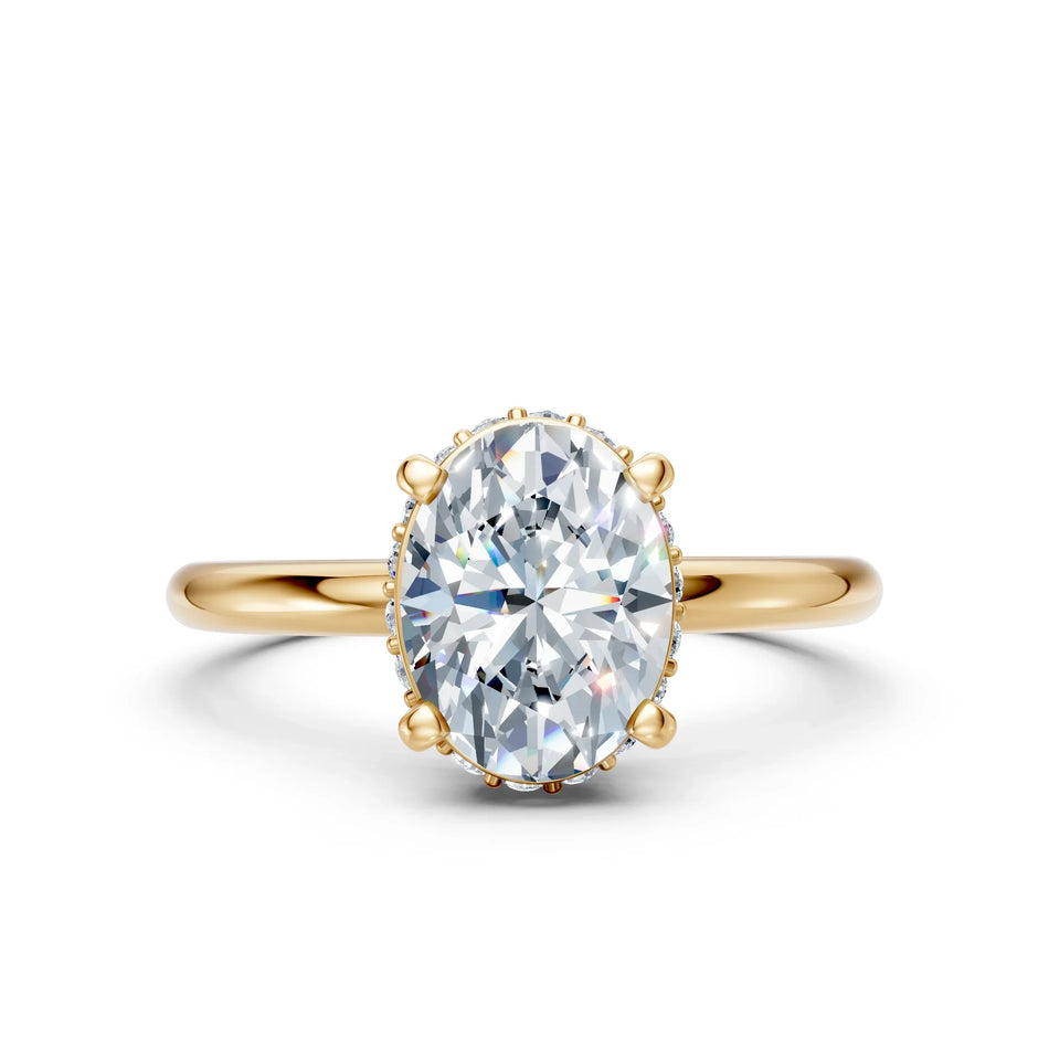 Oval-cut diamond engagement ring with gold band on white background