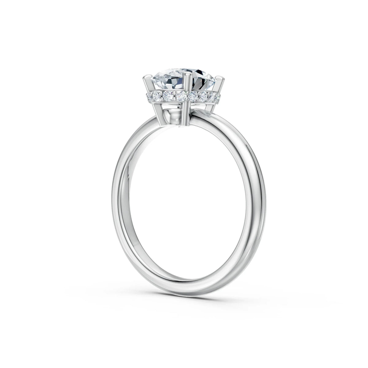 Side view of a solitaire diamond engagement ring with pavé halo on white gold band