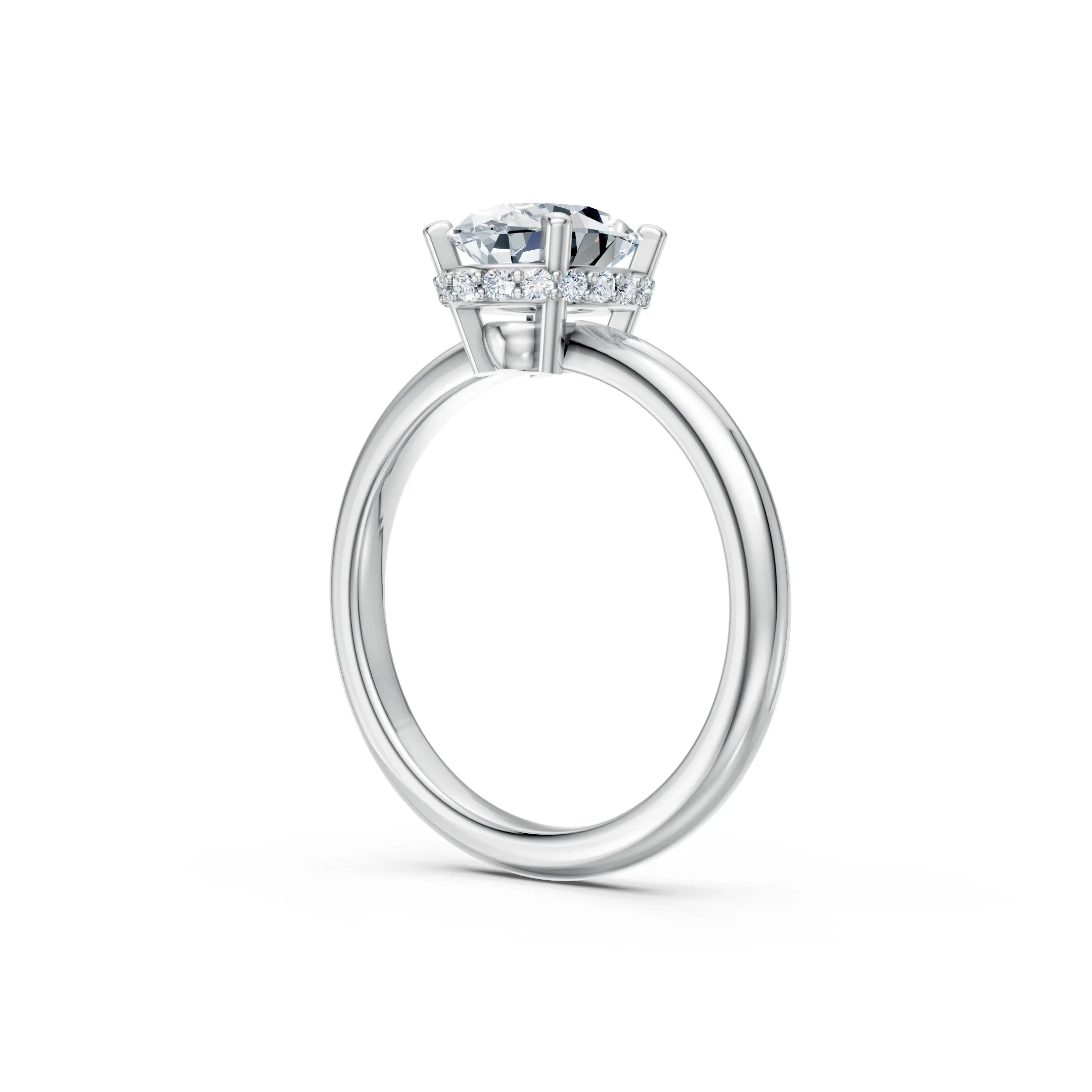 Side view of a solitaire diamond engagement ring with pavé halo on white gold band