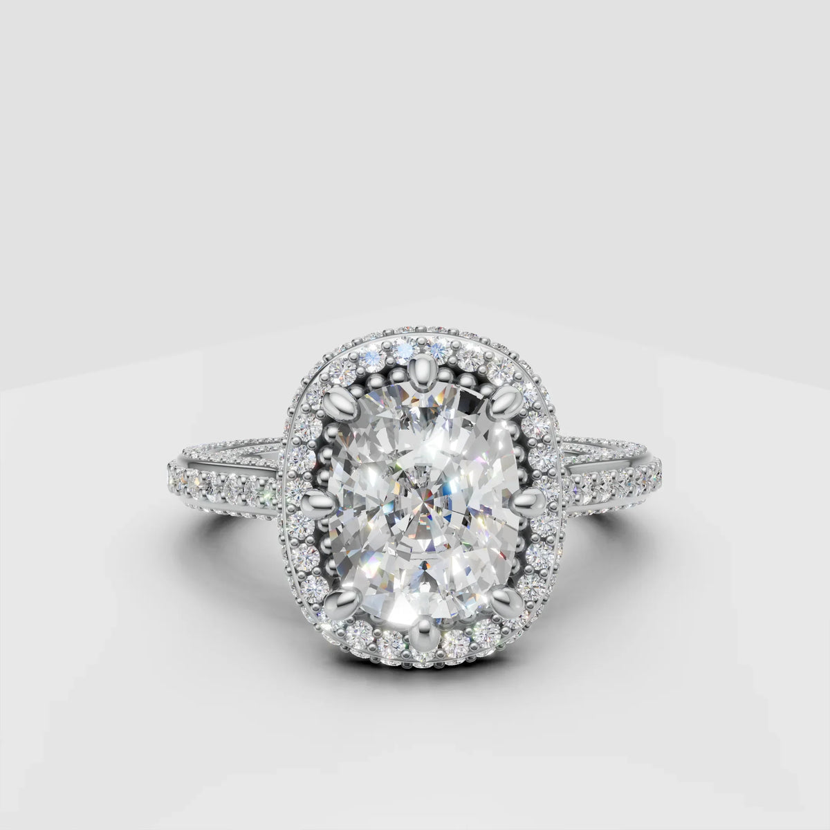 Oval halo diamond engagement ring with pavé band on white background