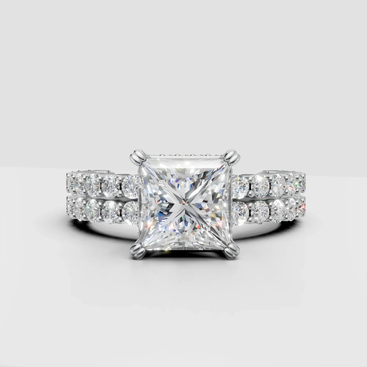 Princess cut diamond engagement ring with double band pavé setting on white background