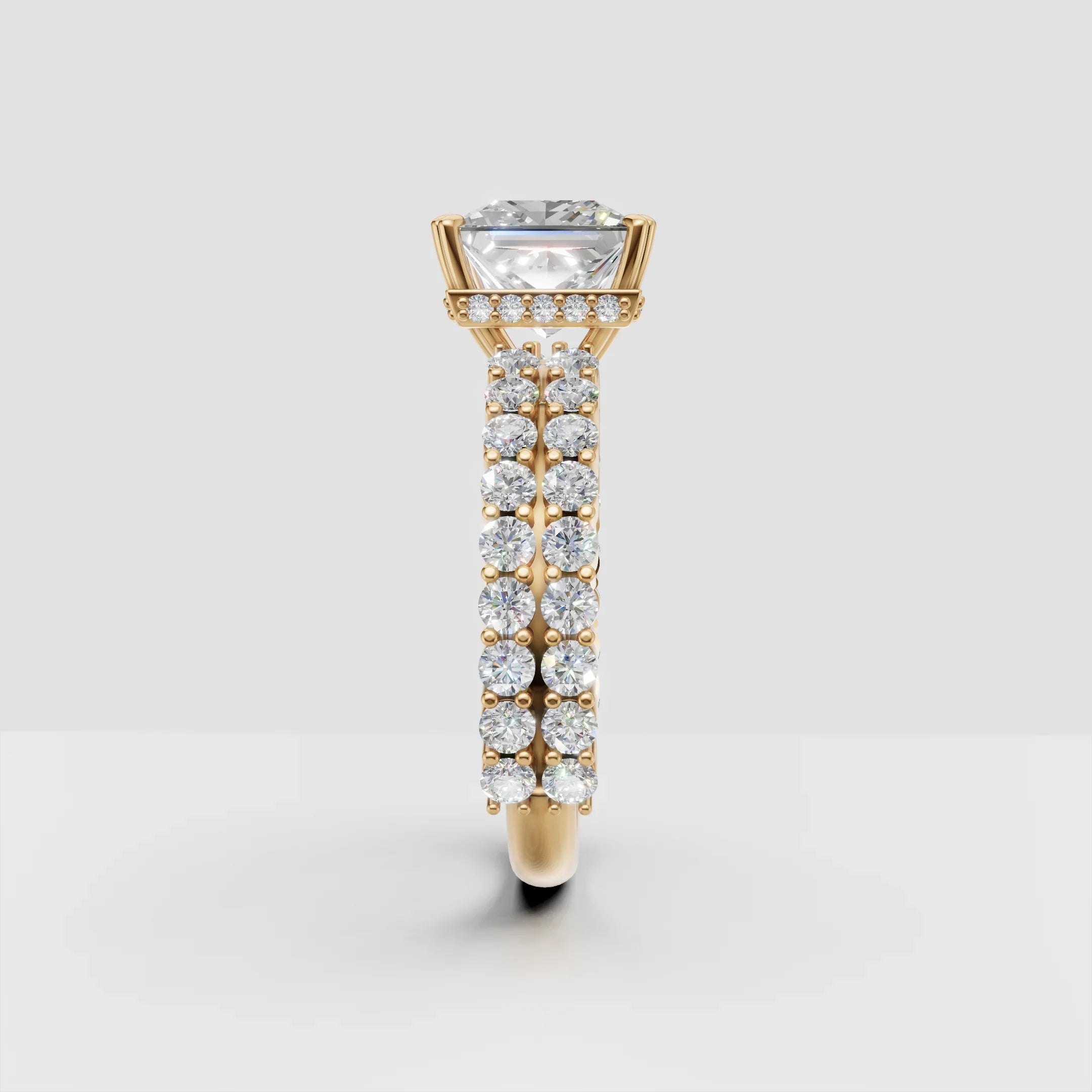 Gold engagement ring with large round diamond and pavé diamond band, side view