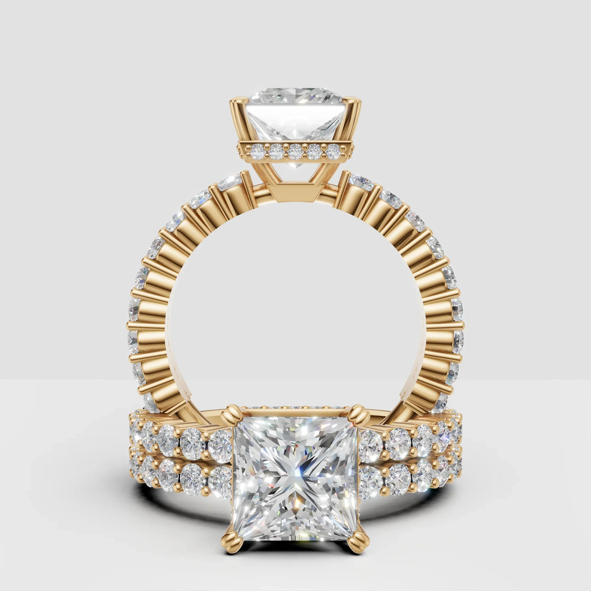 Princess cut diamond engagement ring with gold band and pavé side stones