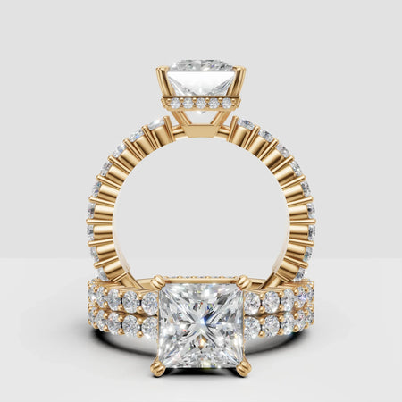 Princess cut diamond engagement ring with gold band and pavé side stones