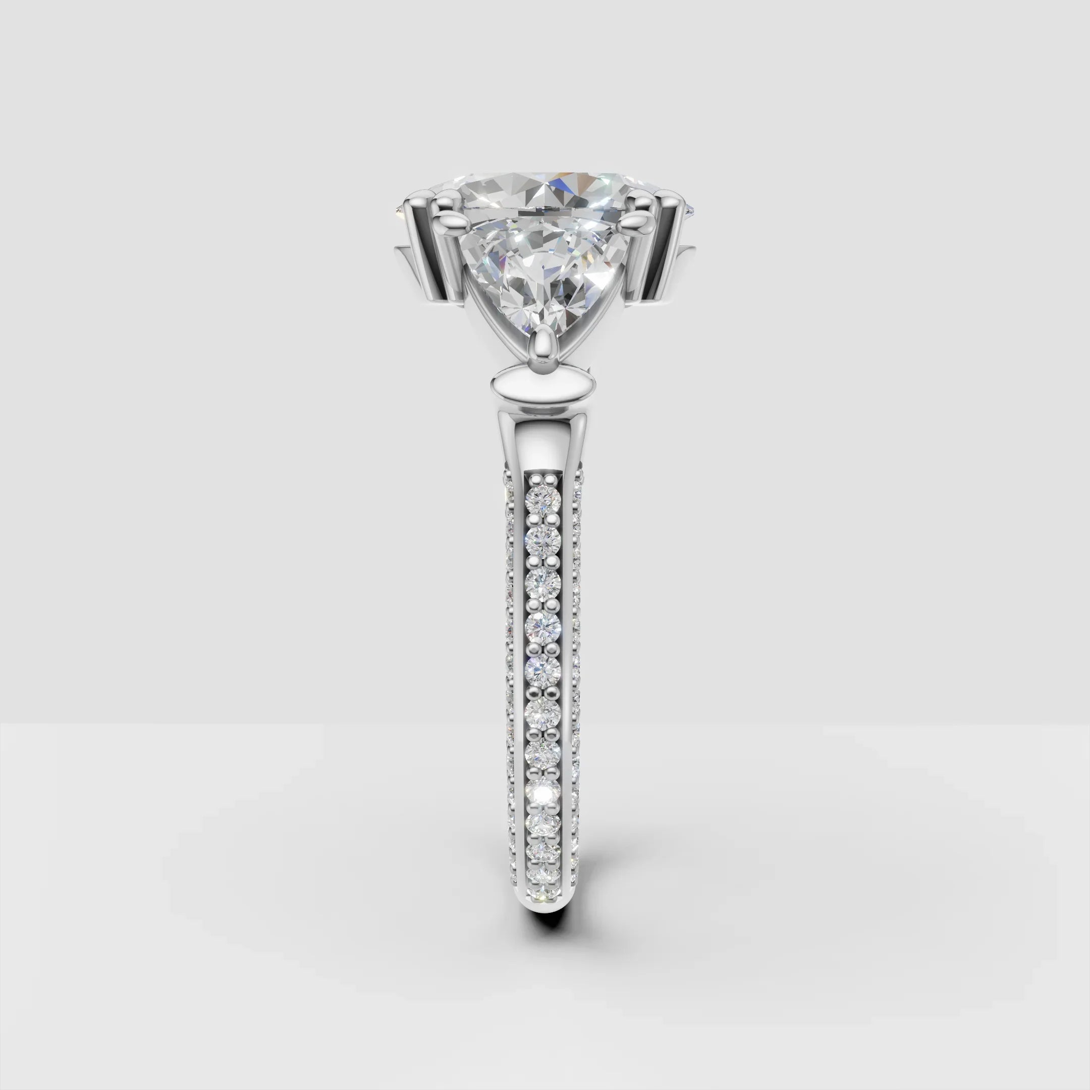 Trillion cut diamond engagement ring with pavé band in white gold, custom jewelry design