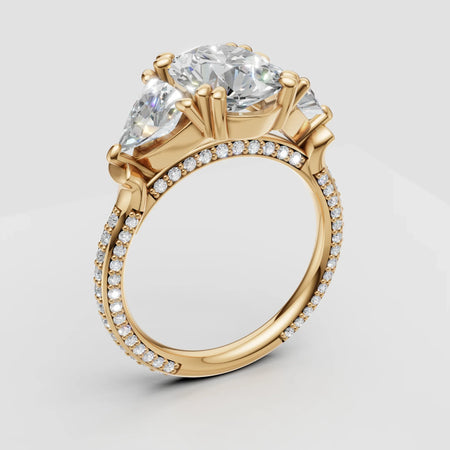 Three stone yellow gold engagement ring with pavé diamond band