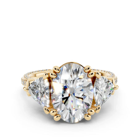 Oval-cut diamond engagement ring with side stones and gold band, custom jewelry design