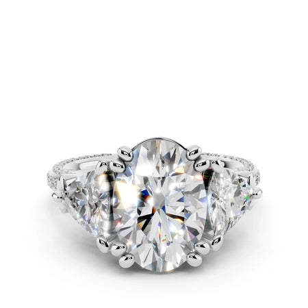 Oval cut three-stone diamond engagement ring in white gold with pavé band