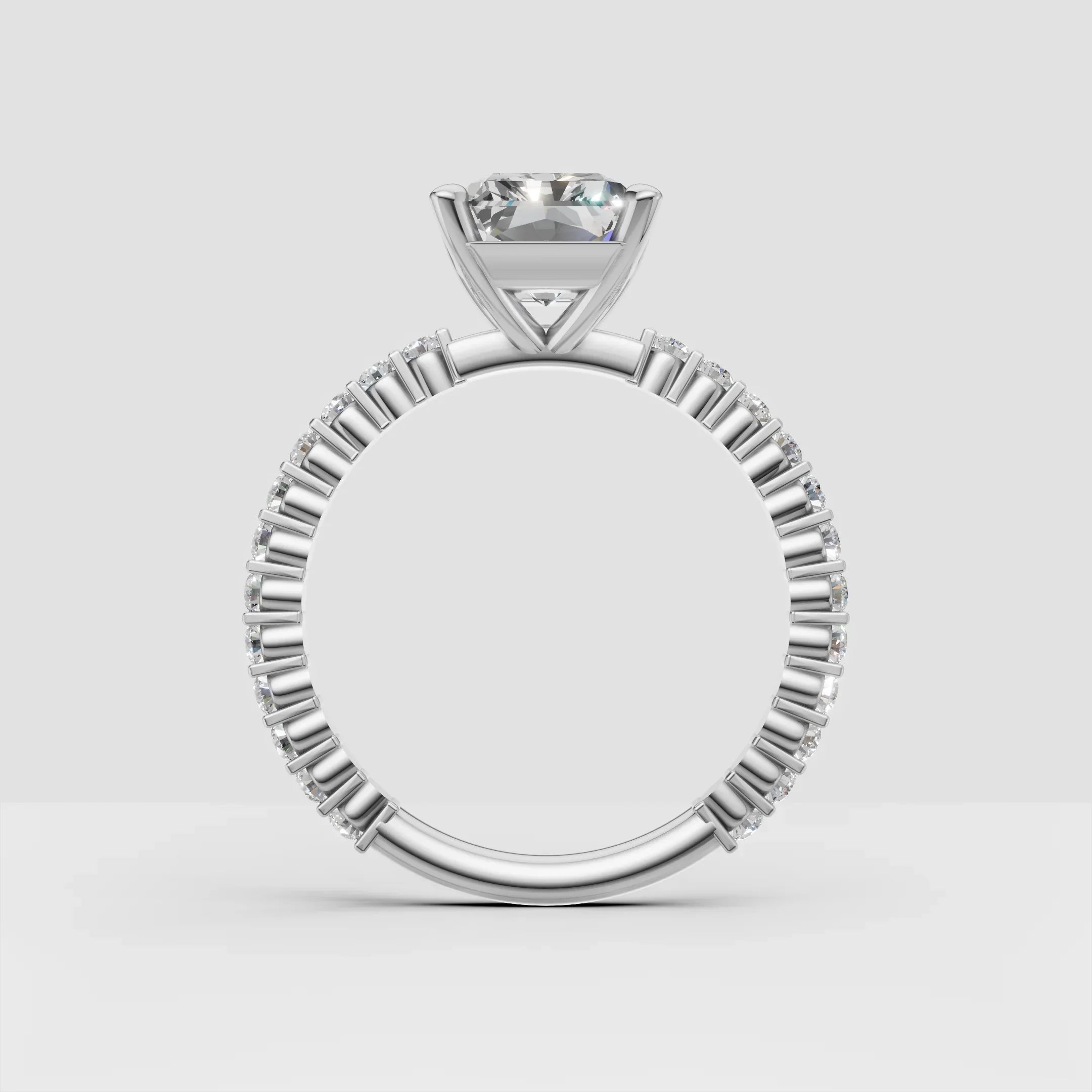 Elegant white gold engagement ring with round diamond center and pavé band
