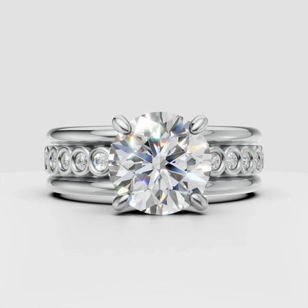 Platinum engagement ring set with large round center diamond and pave band