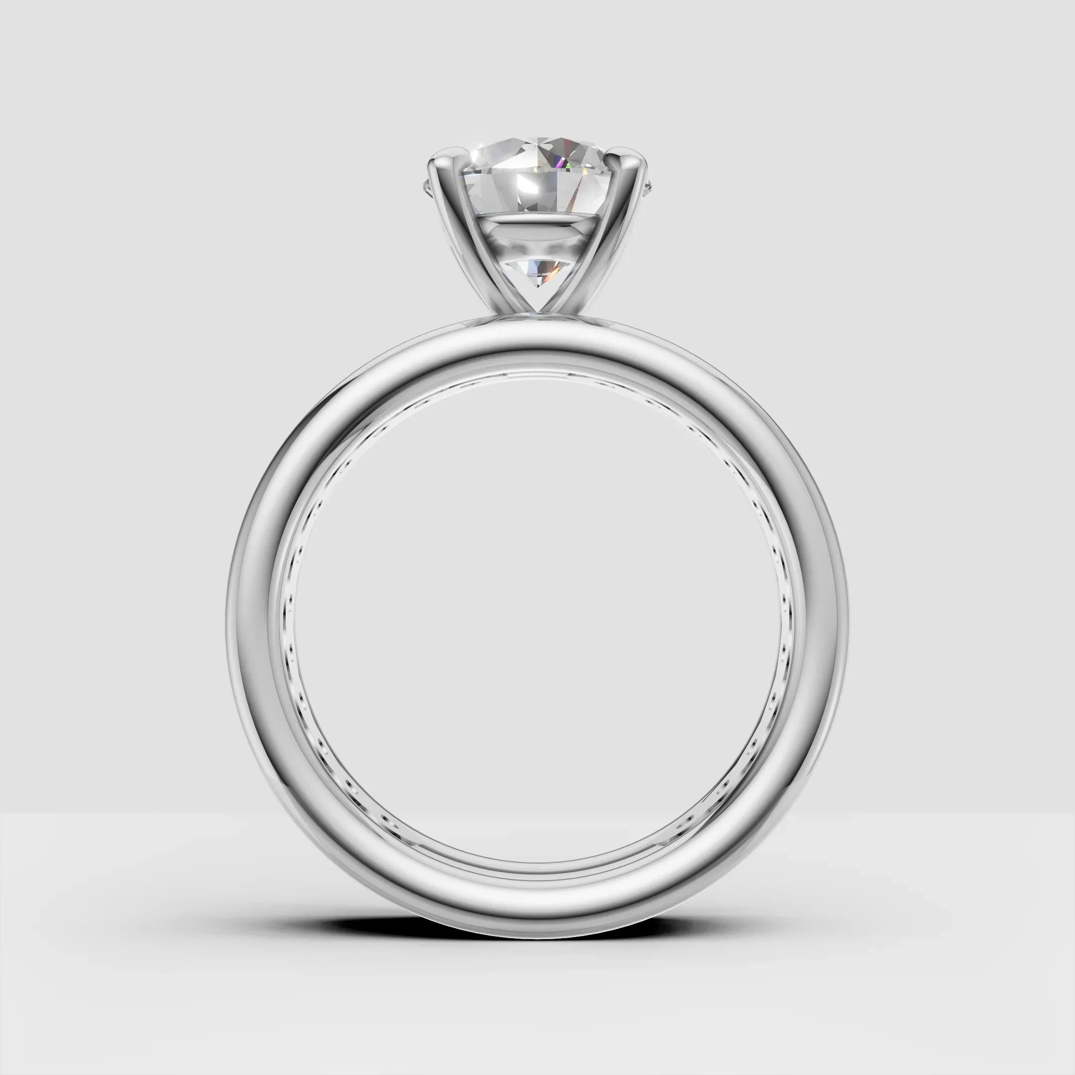 Solitaire diamond engagement ring with a round brilliant cut on white background