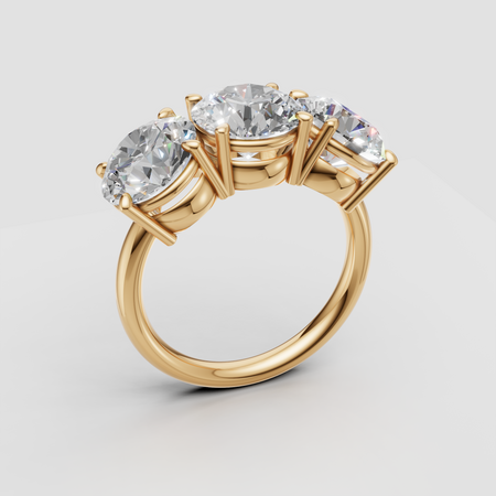 Three stone gold engagement ring with round brilliant diamonds on a white background