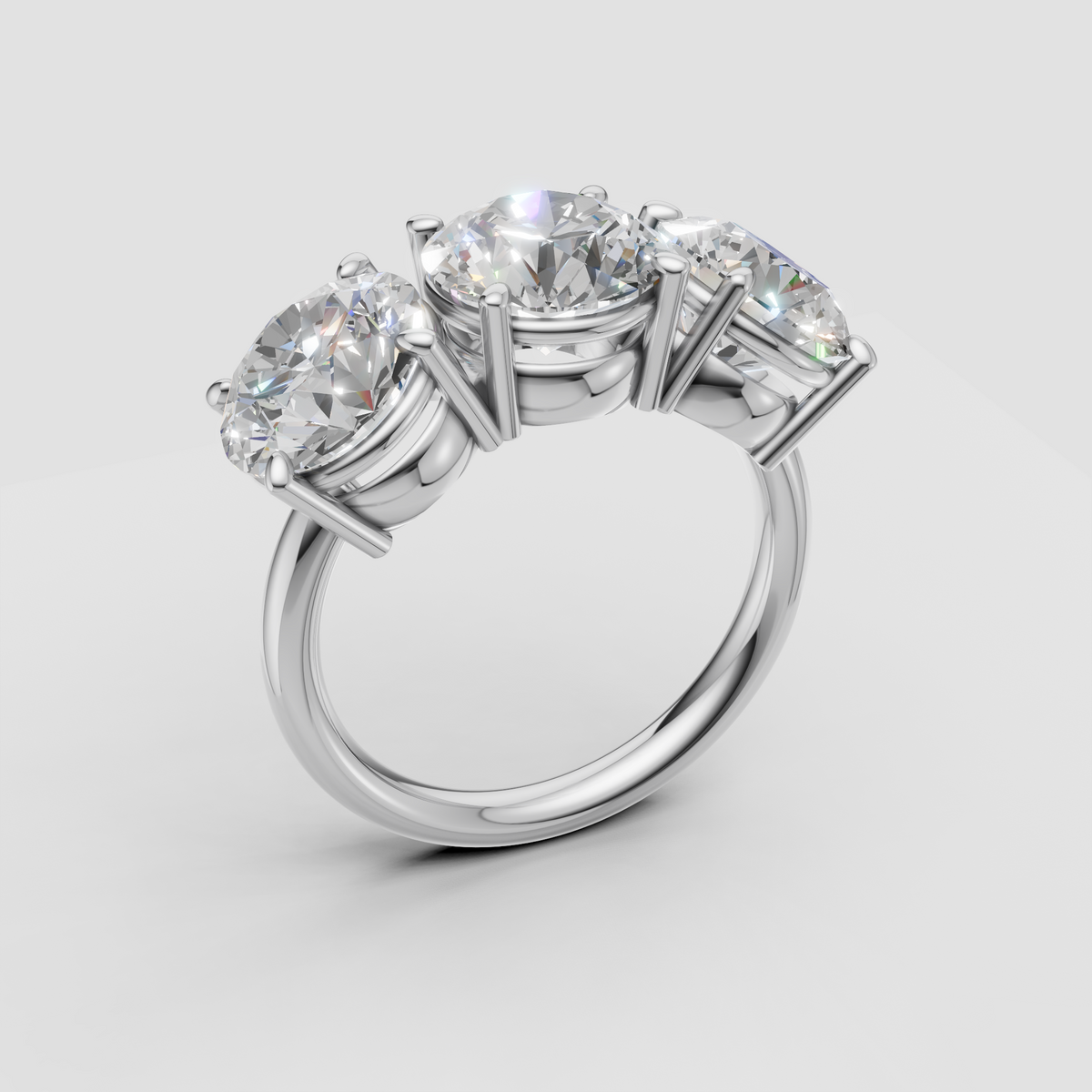 Three stone diamond engagement ring in white gold setting on light background