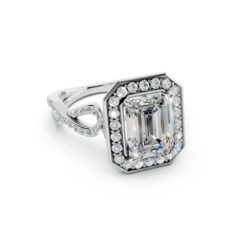 Emerald cut diamond halo engagement ring with twisted pavé band in white gold