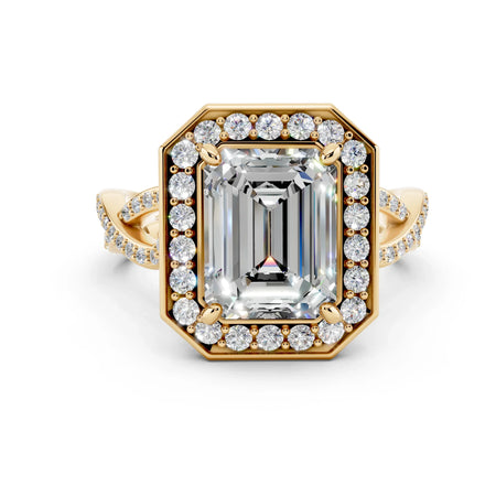 Emerald cut diamond engagement ring with halo setting and twisted yellow gold band