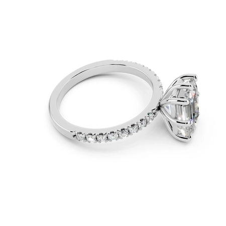 Platinum engagement ring with large oval diamond and pavé diamond band on white background
