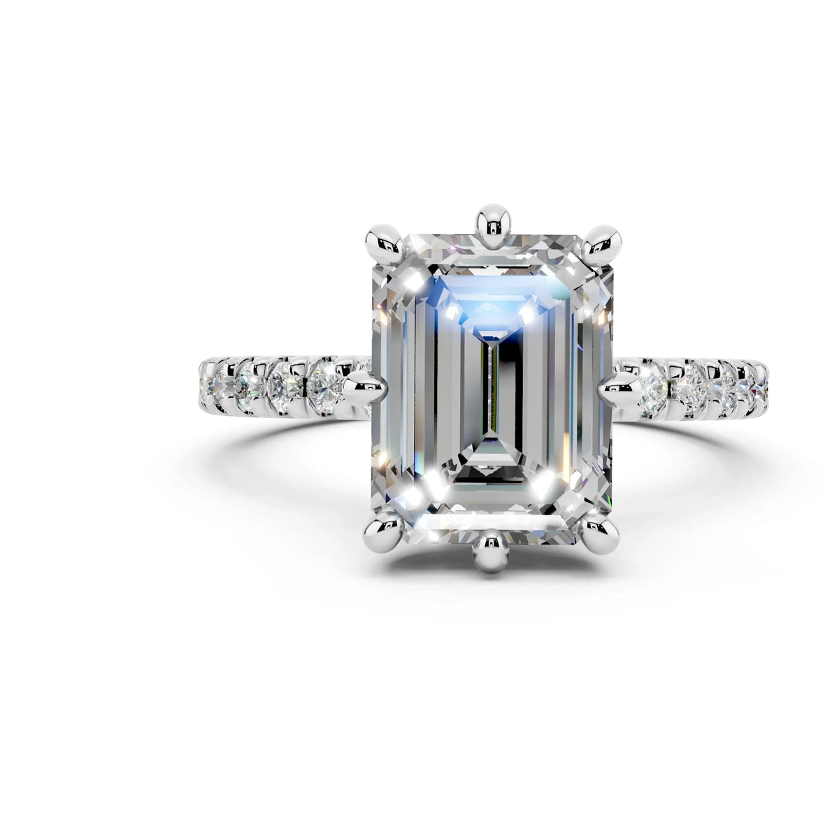 Emerald cut diamond engagement ring with pavé band on white background