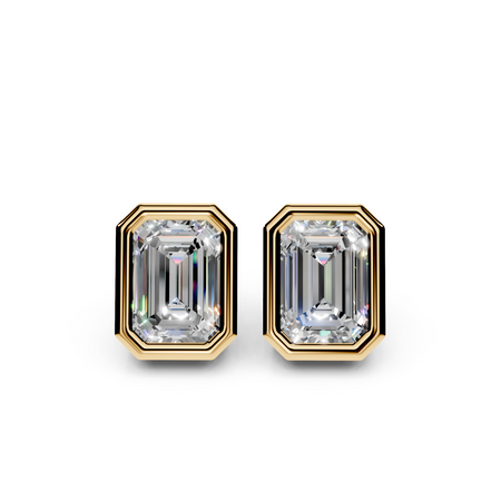 Emerald cut diamond stud earrings in yellow gold bezel settings on white background
