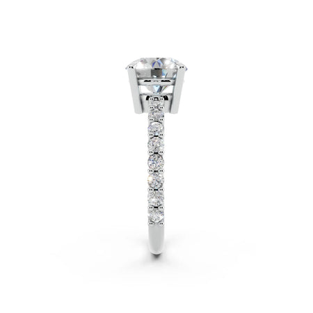 Side view of diamond engagement ring with pavé band in white gold