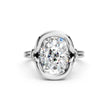 Oval cut diamond engagement ring in a white gold bezel setting