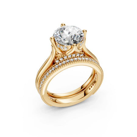 Round brilliant cut diamond engagement ring with pavé gold band and matching wedding band
