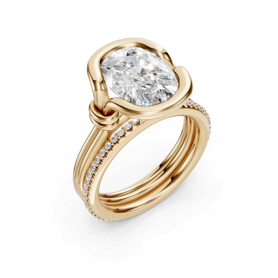 Custom rose gold engagement ring with a large cushion-cut diamond and pavé band.