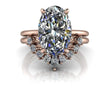 Oval-cut diamond engagement ring with rose gold band and diamond cluster accents