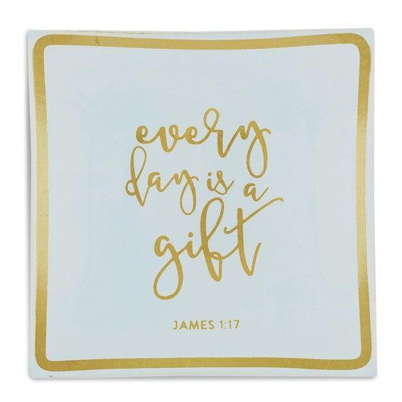 Square bedside jewelry tray with gold trim and 'every day is a gift' script text.