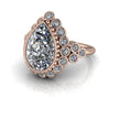Pear-shaped diamond halo engagement ring with rose gold band and round accent stones.