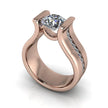 Rose gold engagement ring with a large cushion-cut diamond and channel-set accent stones